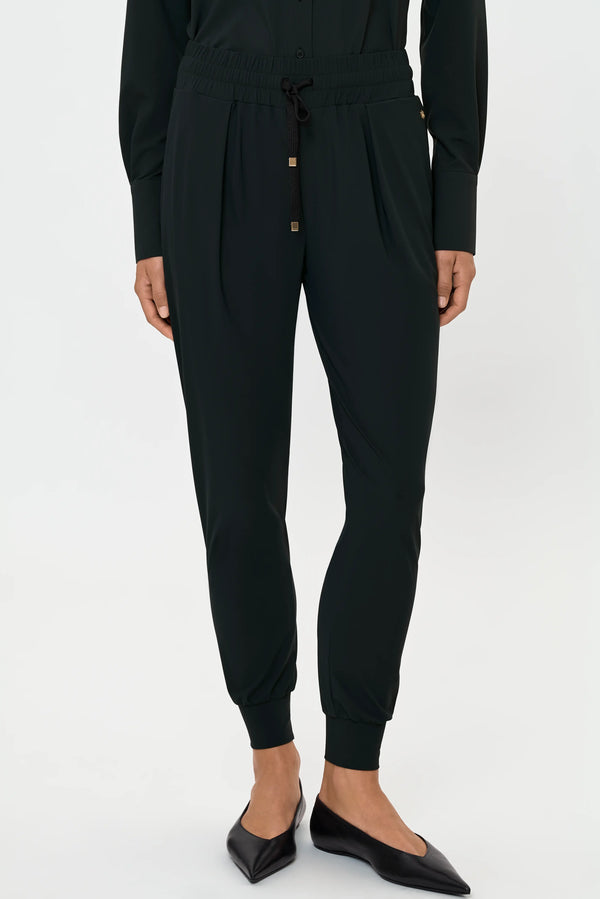 Women's Luxe Léger track pants in forest green featuring a relaxed tapered fit, elastic drawstring waistband, side pockets, and ribbed ankle cuffs.