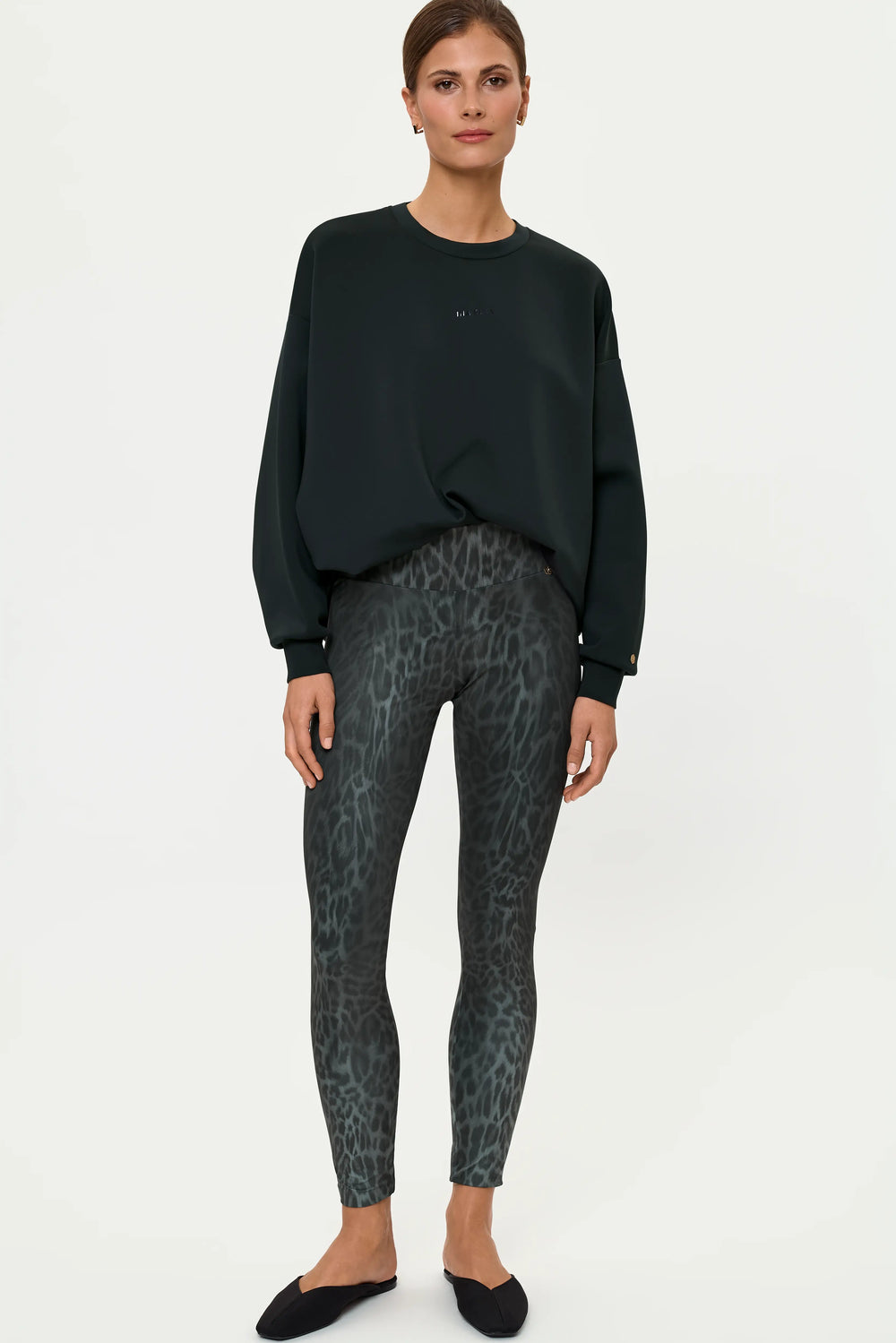 Women's LEOPARDI Diorit leopard print leggings styled with a forest green oversized sweatshirt, front view